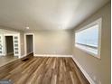 Bright and airy living room featuring hardwood floors and large windows with natural light at 2676 Stone Rd, East Point, GA 30344
