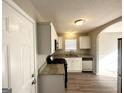 Bright kitchen with white cabinetry, granite countertops, and stainless steel appliances at 315 Breezy Hill Walk, Stockbridge, GA 30281