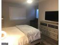 Cozy bedroom with light-colored walls, a bed, a dresser, and natural light at 3834 Kensingwood Trce, Decatur, GA 30032