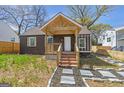 Charming home with a brick porch, exposed rafter tails and landscaped front yard at 1101 Oak Knoll Ter, Atlanta, GA 30315