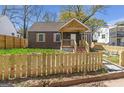 Charming home with a wooden fence surrounding the front yard at 1101 Oak Knoll Ter, Atlanta, GA 30315