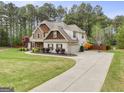 Expansive lawn and long driveway leading to a charming home with basketball hoop for outdoor enjoyment at 100 Chantilly Ln, Fayetteville, GA 30215