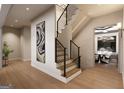 Inviting home entryway featuring hardwood floors, modern staircase, and stylish decor at 2700 Antioch Ne St, Conyers, GA 30013