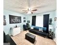 This stylish bedroom features a black futon sofa, a ceiling fan, and light blue walls, great for relaxing at 3353 Medina Dr, Jonesboro, GA 30236