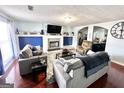 Cozy living room featuring comfortable seating, a fireplace with white mantel and blue accents on the walls at 3353 Medina Dr, Jonesboro, GA 30236