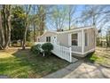 Inviting single-story home with a quaint white picket fence and easy access ramp at 351 Hemlock Ln, Locust Grove, GA 30248
