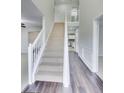 Bright foyer with high ceilings, hardwood floors, staircase with white railing, and open layout at 540 Hamlet Dr, Hampton, GA 30228