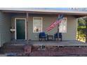 Inviting front porch with an American flag and seating area at 4941 Old Atlanta Rd, Hampton, GA 30228