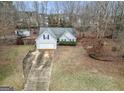 Aerial view of a well-maintained single-Gathering home with a long driveway at 1103 Larkspur Dr, Locust Grove, GA 30248