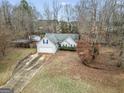 Overhead view of a well-manicured single-Gathering home with a spacious driveway at 1103 Larkspur Dr, Locust Grove, GA 30248