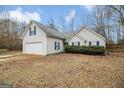 Inviting single-Gathering home boasts a two-car garage and manicured landscaping at 1103 Larkspur Dr, Locust Grove, GA 30248