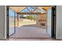 Covered patio features a stone fireplace, wood ceiling and fan, and backyard views at 1230 Hayes Sq, Peachtree City, GA 30269