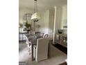 Elegant dining room with modern chandelier, stylish rug, and complementary decor creating an inviting atmosphere at 813 Creekgarden Court, Atlanta, GA 30339