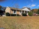 A classic brick home with shutters and a welcoming front porch supported by white columns at 6099 Winview Dr, Forest Park, GA 30297