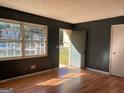 Living room with natural light, hardwood floors, and a view of the front yard through a large window at 6332 Valley Dale Dr, Riverdale, GA 30274