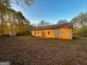 Back of the house with spacious yard, storage shed, and covered parking area at 117 Old Stagecoach Rd, Carrollton, GA 30116