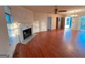 Bright living room with fireplace, hardwood floors, and a ceiling fan at 117 Old Stagecoach Rd, Carrollton, GA 30116