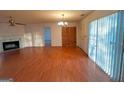Spacious living room featuring a fireplace, hardwood floors, and plenty of natural light at 117 Old Stagecoach Rd, Carrollton, GA 30116