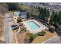 A high angle shot of the community pool and tennis court and surrounding homes at 4654 Liberty Square Dr, Acworth, GA 30101