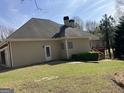 Residential home with a fenced backyard, featuring a deck and a well-maintained lawn at 9039 River Bend Ct, Villa Rica, GA 30180