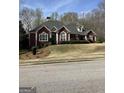 Beautiful brick home with arched windows, trimmed hedges, and a professionally landscaped front yard for curb appeal at 9039 River Bend Ct, Villa Rica, GA 30180