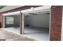 Spacious two car garage with plenty of natural light, painted floors, and ample storage space at 9039 River Bend Ct, Villa Rica, GA 30180