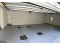 Clean and spacious garage with painted floors, an exterior door, and built in shelving for storage solutions at 9039 River Bend Ct, Villa Rica, GA 30180
