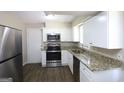 Well-equipped kitchen featuring stainless steel appliances and granite countertops at 1751 Woodsloe Dr, Decatur, GA 30035