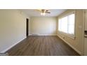 Bright living room with ceiling fan, large window, and wood-look flooring at 2823 Horse Shoe Dr, Atlanta, GA 30316