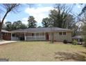 Classic brick ranch-style home with covered parking and a cozy front porch at 3065 Glendale Ct, Decatur, GA 30032