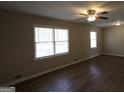 Bright living room with hardwood floors, ceiling fan and natural light from a large window at 4044 Lindsey Dr, Decatur, GA 30035