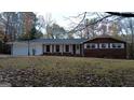 Lovely brick ranch home with white trim, covered porch, and mature trees at 1351 John Robert Dr, Morrow, GA 30260