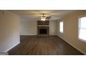 Spacious living room featuring new flooring, a brick fireplace, and abundant natural light at 756 Sugar Hill Ln, Conyers, GA 30094