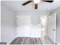 Neutral bedroom with light gray paint and vinyl floors and an open closet at 102 Neal Ave, Stockbridge, GA 30281