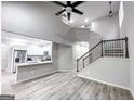 Open living space featuring modern vinyl floors, stairs, and a combined kitchen space at 102 Neal Ave, Stockbridge, GA 30281