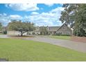Charming two-story home with a stone facade, a circular driveway and a well-maintained yard at 676 Mcbride Rd, Fayetteville, GA 30215