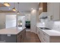 Modern kitchen with white cabinets, a large center island, and stainless steel appliances at 4080 Whitney Rd, Social Circle, GA 30025