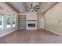 Spacious living room featuring a cozy fireplace, custom built-ins, and plenty of natural light at 4080 Whitney Rd, Social Circle, GA 30025