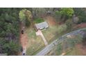 Aerial view of property showing home, yard, driveway, and surrounding mature trees at 1910 Reese Rd, Rutledge, GA 30663