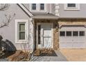 Close-up of the front door with stone accents and a welcome mat, showcasing the home's entryway at 4180 Pineset Dr, Alpharetta, GA 30022