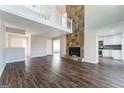 Spacious living room with a stone fireplace, hardwood floors, and loft overlook at 4180 Pineset Dr, Alpharetta, GA 30022