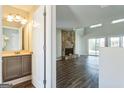 Open-concept living room featuring a stone fireplace, hardwood floors, and natural light at 4180 Pineset Dr, Alpharetta, GA 30022