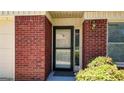 Close-up of the home's front door framed by red brick and lush landscaping at 6192 Douglas Manor Ct, Douglasville, GA 30134