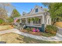 Charming home with an inviting front porch, lush landscaping, and classic architectural details at 2173 Conyers Se St, Covington, GA 30014