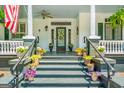 Inviting front porch adorned with colorful potted plants, offering a warm welcome and a glimpse of southern charm at 2173 Conyers Se St, Covington, GA 30014