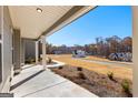 Inviting covered front porch with elegant columns and a view of the landscaped front yard and neighboring homes at 279 Deer Creek Run # 4, Moreland, GA 30259