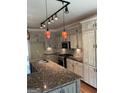 Spacious kitchen features granite counters, stainless appliances, tile backsplash, a large island and custom cabinets at 1081 Bridge Mill Ave, Canton, GA 30114
