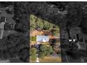 Aerial view of a house situated on a well-defined lot surrounded by mature trees and neighboring houses at 1190 N Ola Rd, Mcdonough, GA 30252