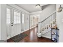 Inviting foyer with hardwood floors, staircase, and ample natural light creating a warm entry at 4435 Ross Estates Ct, Snellville, GA 30039