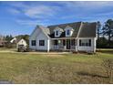 Inviting home with a covered front porch, manicured lawn, and a classic architectural design at 1222 Snapping Shoals Rd, Mcdonough, GA 30252